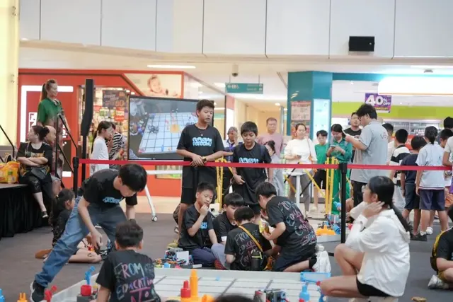 Young teams competing at the robotics tournament floor