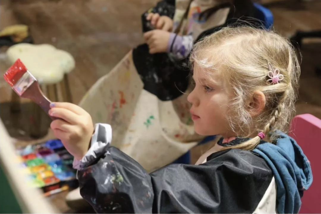 A child painting with a brush